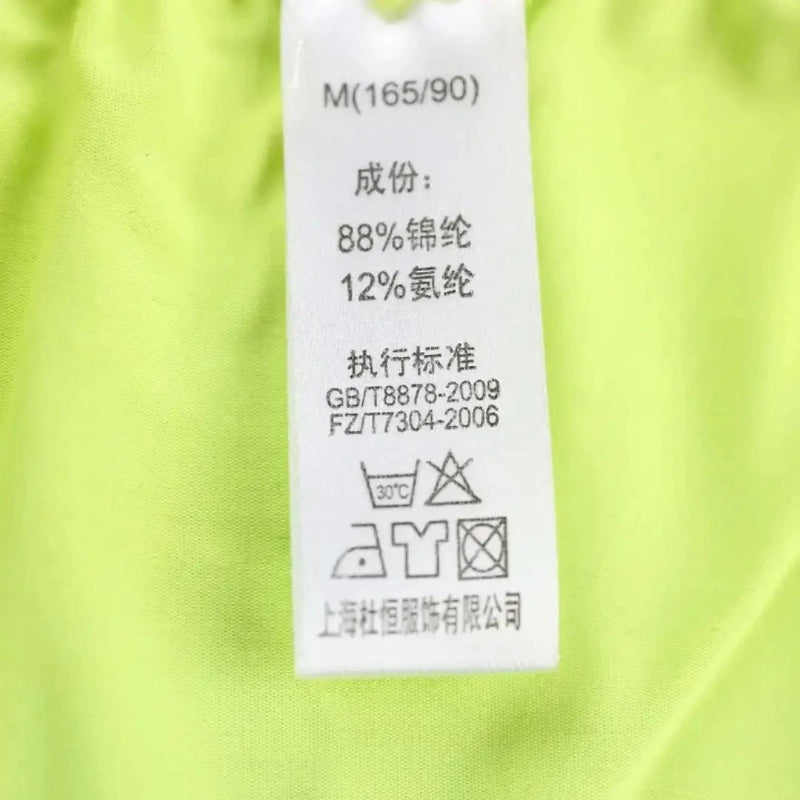 DomiGe lightweight woven fabric texture close-up — breathable laser-cut boxer shorts bright green