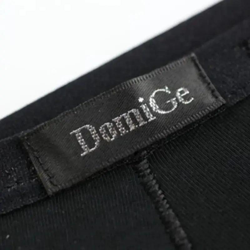 Embossed logo elastic waistband close-up — modal low-rise briefs DomiGe black