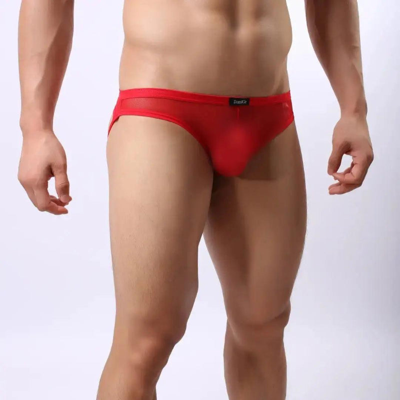 Model wearing DomiGe mesh jockstrap side view — open-back leg straps Red

