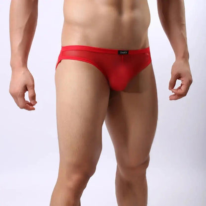 Model wearing DomiGe mesh jockstrap side view — open-back leg straps Red
