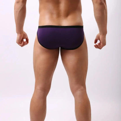 Model wearing DomiGe modal low-rise briefs — embossed waistband back angle Purple