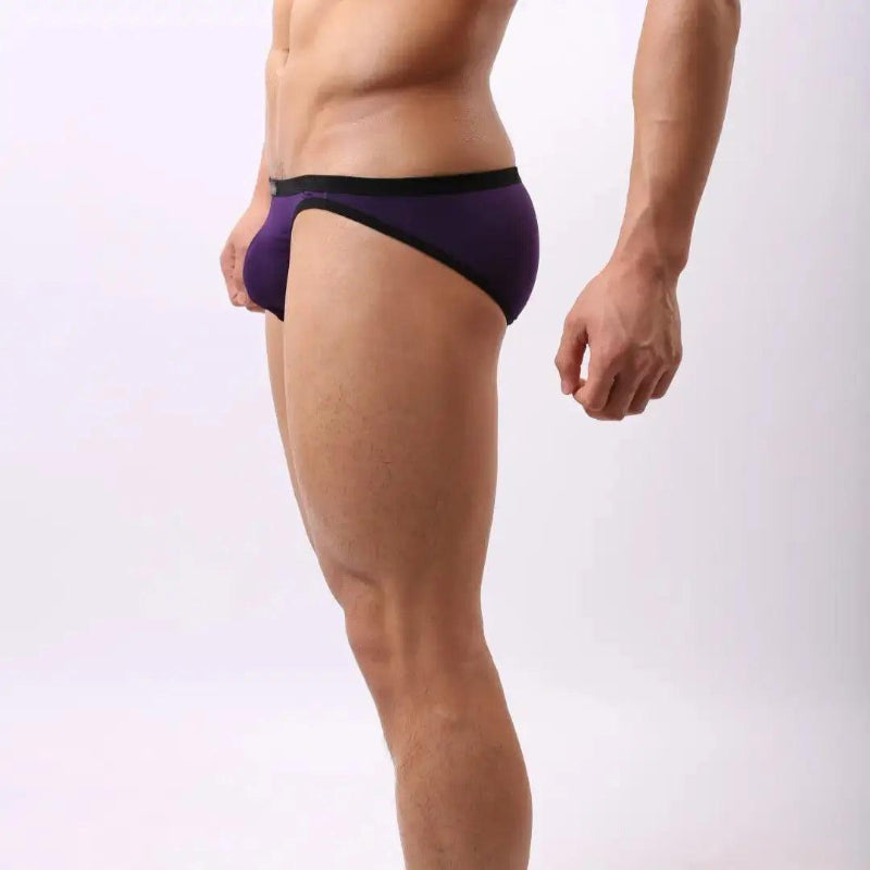 Model wearing DomiGe modal low-rise briefs — embossed waistband side angle Purple