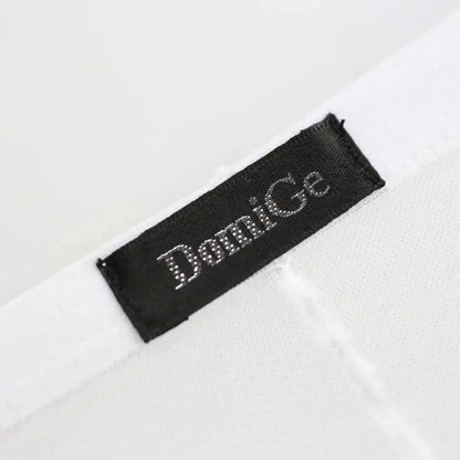 Model wearing DomiGe sheer briefs — logo waistband low-rise back angle White detail