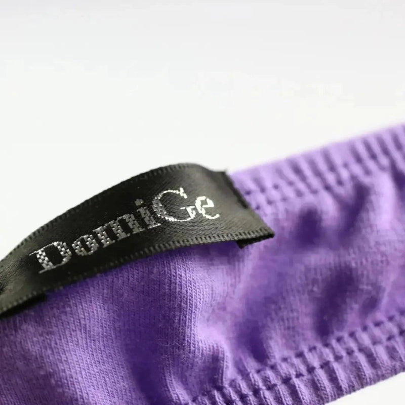 Side personality strap detail close-up — cotton thong bold seductive design DomiGe logo