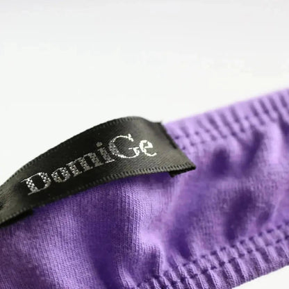 Side personality strap detail close-up — cotton thong bold seductive design DomiGe logo