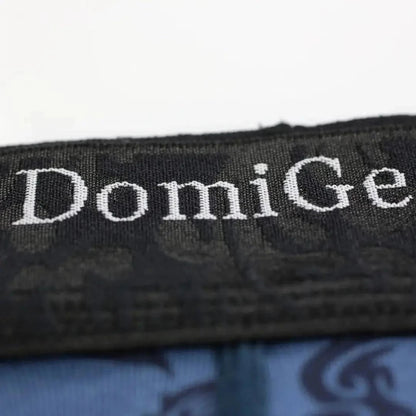 Close-up of DomiGe brand logo precision-woven into bamboo fiber fabric using CAD weaving technology on cobalt blue boxer briefs	