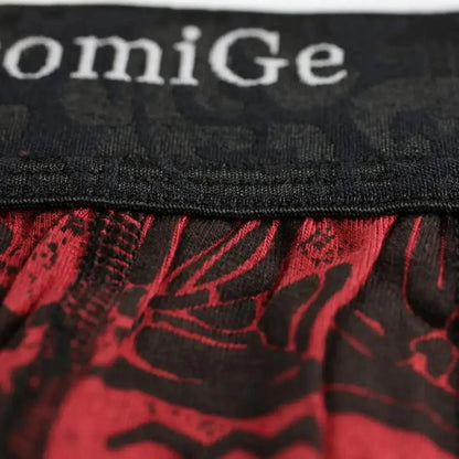 Close-up of DomiGe 3.5cm black waistband with dark floral pattern and woven white DomiGe logo on red print bamboo boxer briefs	
