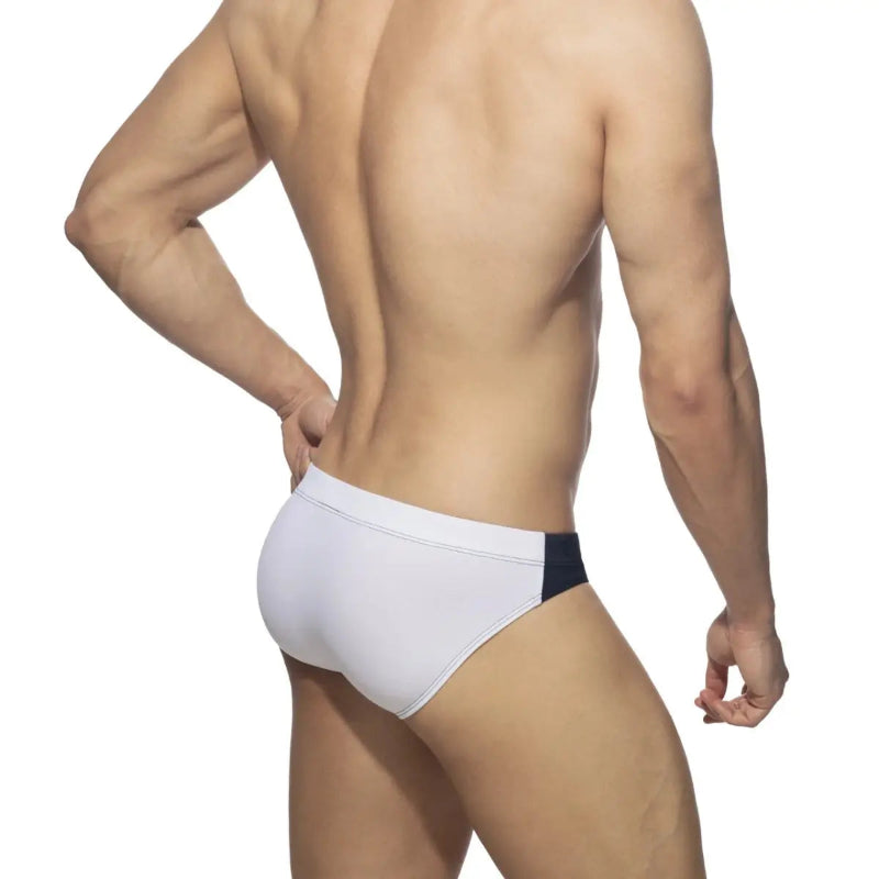 DomiGe colorblock swim brief in navy — model rear view showing fit	