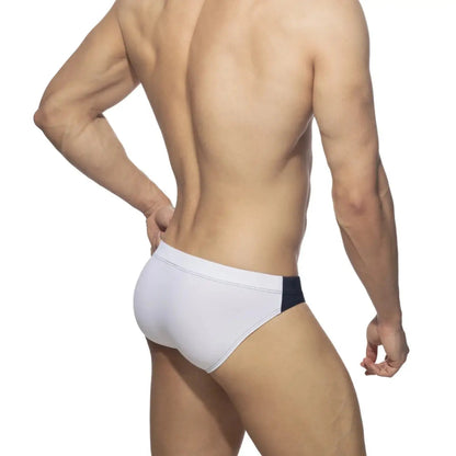 DomiGe colorblock swim brief in navy — model rear view showing fit	