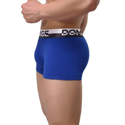 DomiGe cotton boxer briefs turtle shell pouch in blue — model side view showing silver logo waistband	