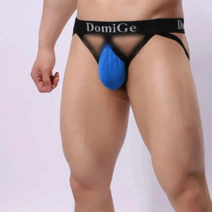 DomiGe cotton lycra jockstrap in blue — model side view showing W-shape back and silver logo waistband	