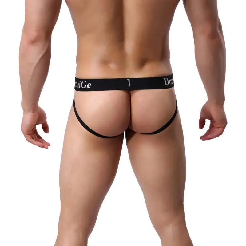 DomiGe cotton lycra jockstrap in navy — model rear view showing W-shape cross-strap design	