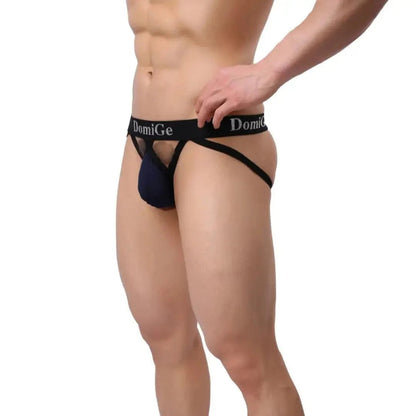 DomiGe cotton lycra jockstrap in navy — model side view showing W-shape back straps and 3.5cm silver logo waistband	