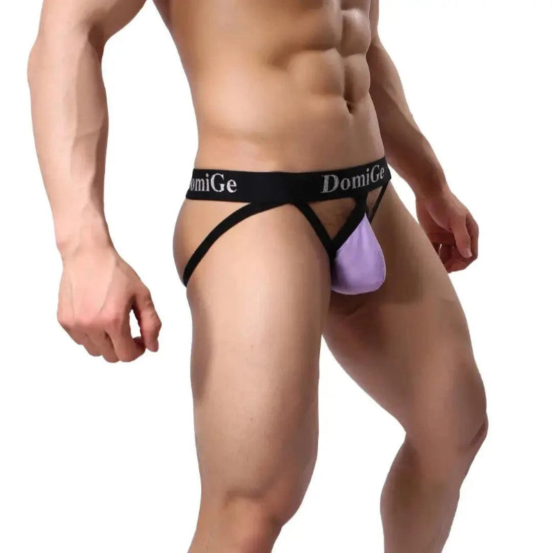 DomiGe cotton lycra jockstrap in purple — model side view showing W-shape back and silver logo waistband	
