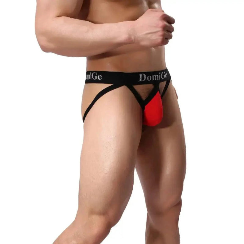 DomiGe cotton lycra jockstrap in red — model side view showing W-shape back and silver logo waistband	