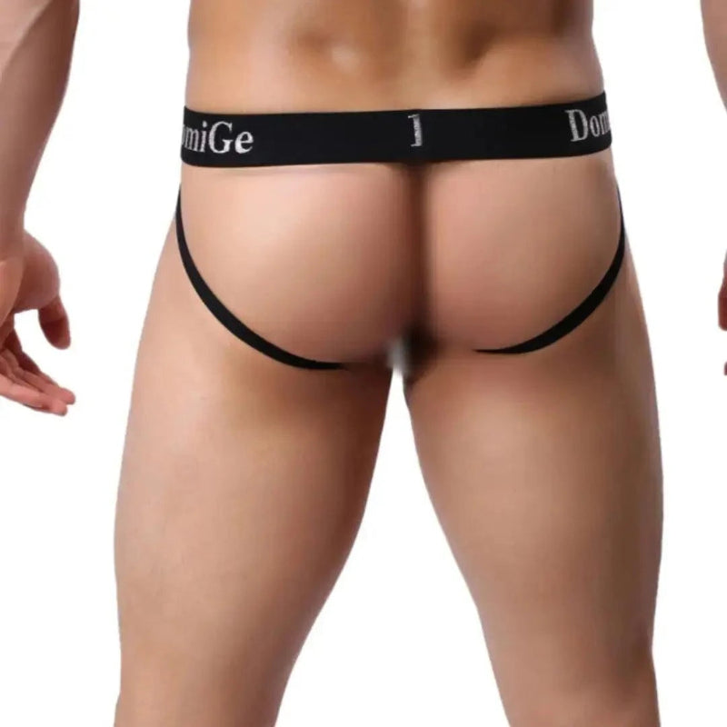 DomiGe cotton lycra jockstrap in royal blue — model side view showing W-shape back and silver logo waistband	