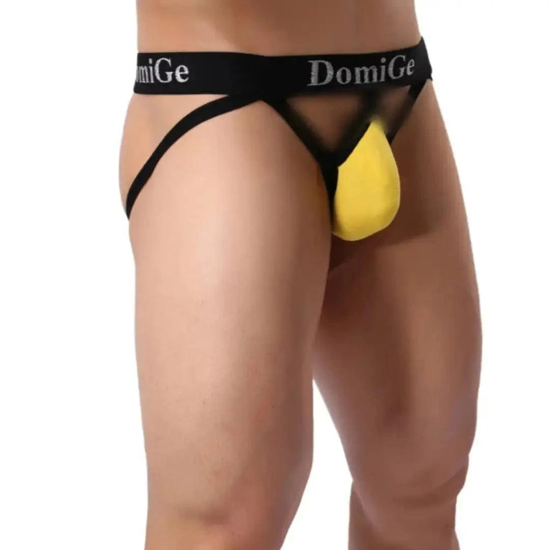 DomiGe cotton lycra jockstrap in yellow — model side view showing W-shape back and silver logo waistband	