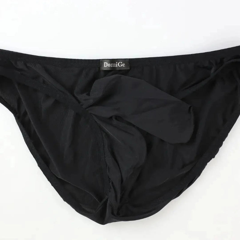 DomiGe elephant cock sock briefs in black — flat lay front view showing elephant trunk pouch design	