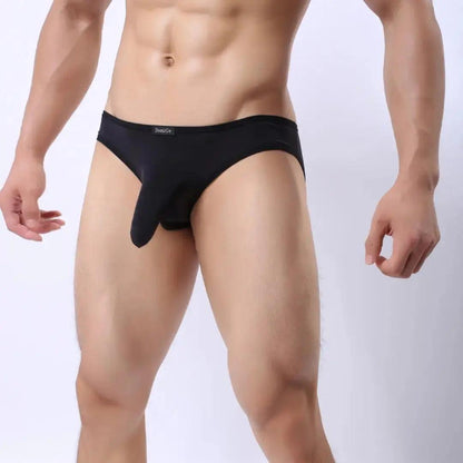 DomiGe elephant cock sock pouch briefs in black — model side view showing low-rise fit and contoured pouch	