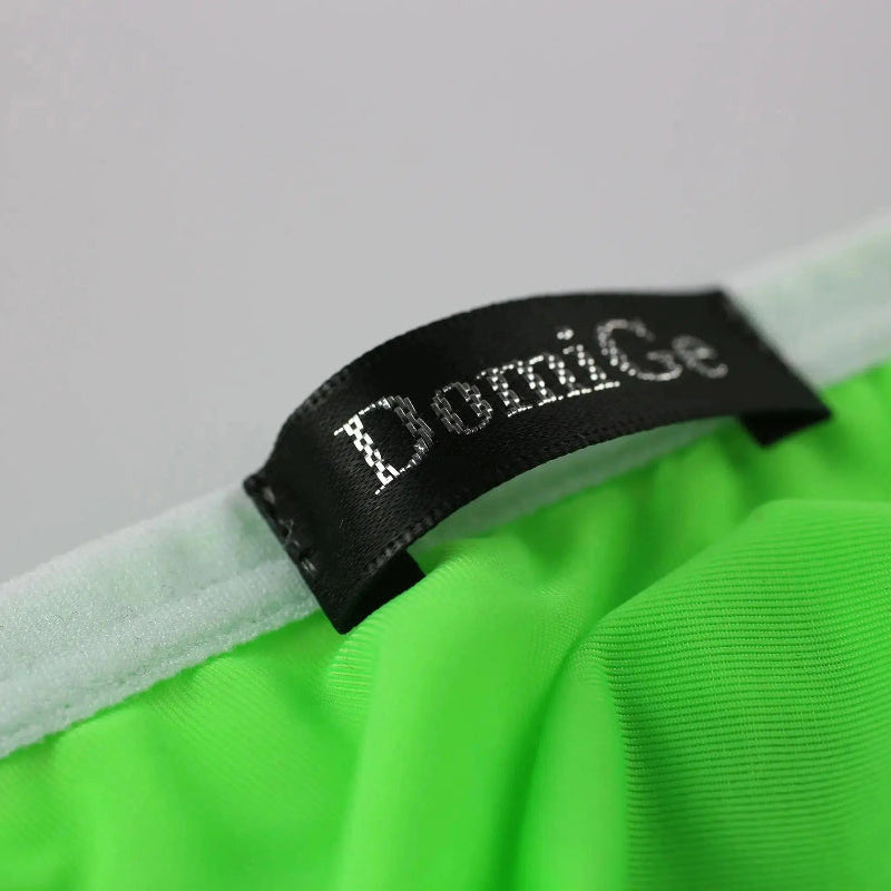 DomiGe elephant cock sock briefs in bright green — flat lay side view showing contoured pouch and waistband	