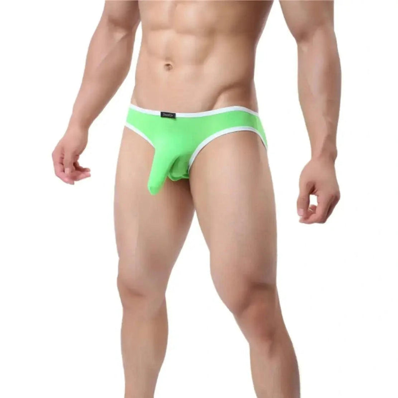 DomiGe elephant cock sock pouch briefs in bright green — model side view showing low-rise fit and contoured pouch	