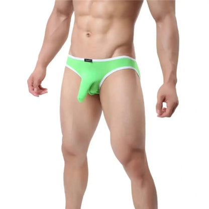 DomiGe elephant cock sock pouch briefs in bright green — model side view showing low-rise fit and contoured pouch	