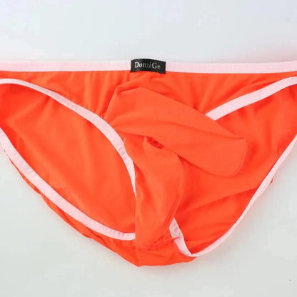 DomiGe elephant cock sock briefs in orange — flat lay front view showing elephant trunk pouch design	