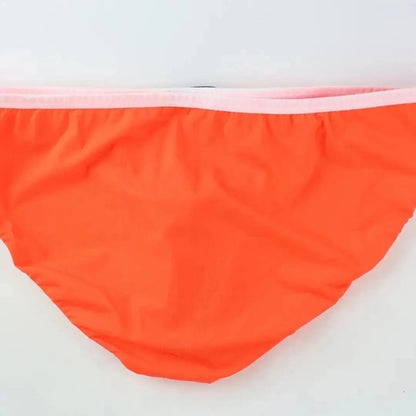 DomiGe elephant cock sock briefs in orange — flat lay side view showing contoured pouch and waistband	