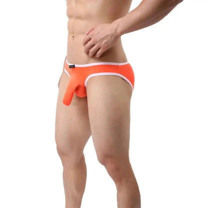 DomiGe elephant cock sock pouch briefs in orange — model side view showing low-rise fit and contoured pouch	