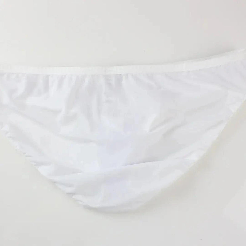 DomiGe elephant cock sock briefs in white — flat lay side view showing contoured pouch and waistband	