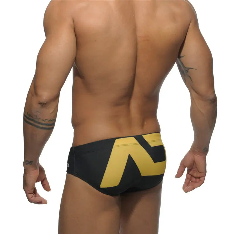 DomiGe fashion swim briefs in black — model rear view	