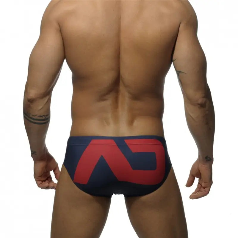 DomiGe fashion swim briefs in navy — model rear view	