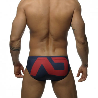 DomiGe fashion swim briefs in navy — model rear view	