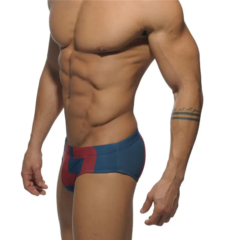 DomiGe fashion swim briefs in navy — model side view	