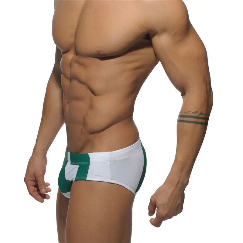 DomiGe fashion swim briefs in white — model side view	