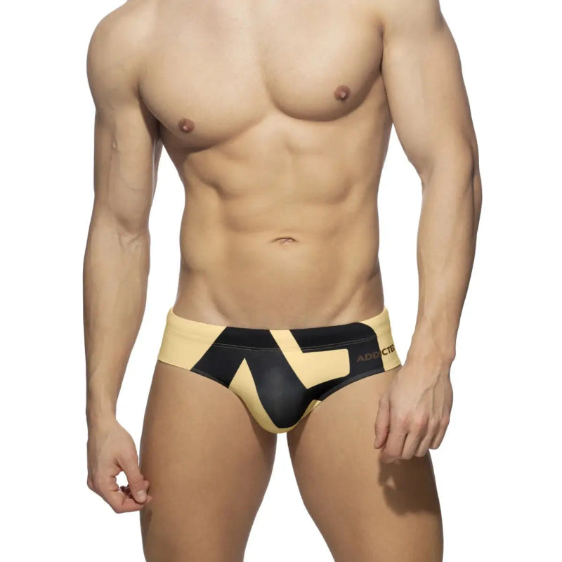 DomiGe fashion swim briefs in yellow — model front view	
