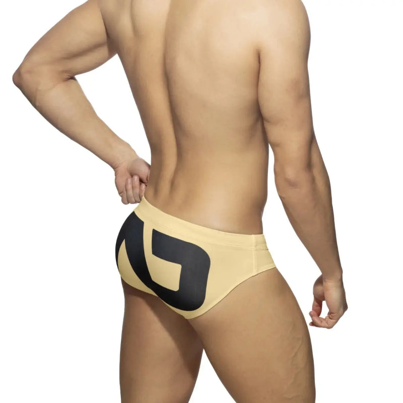 DomiGe fashion swim briefs in yellow — model rear view	