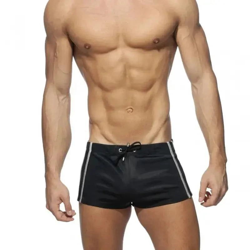 DomiGe faux leather swim boxers in black — model front view	