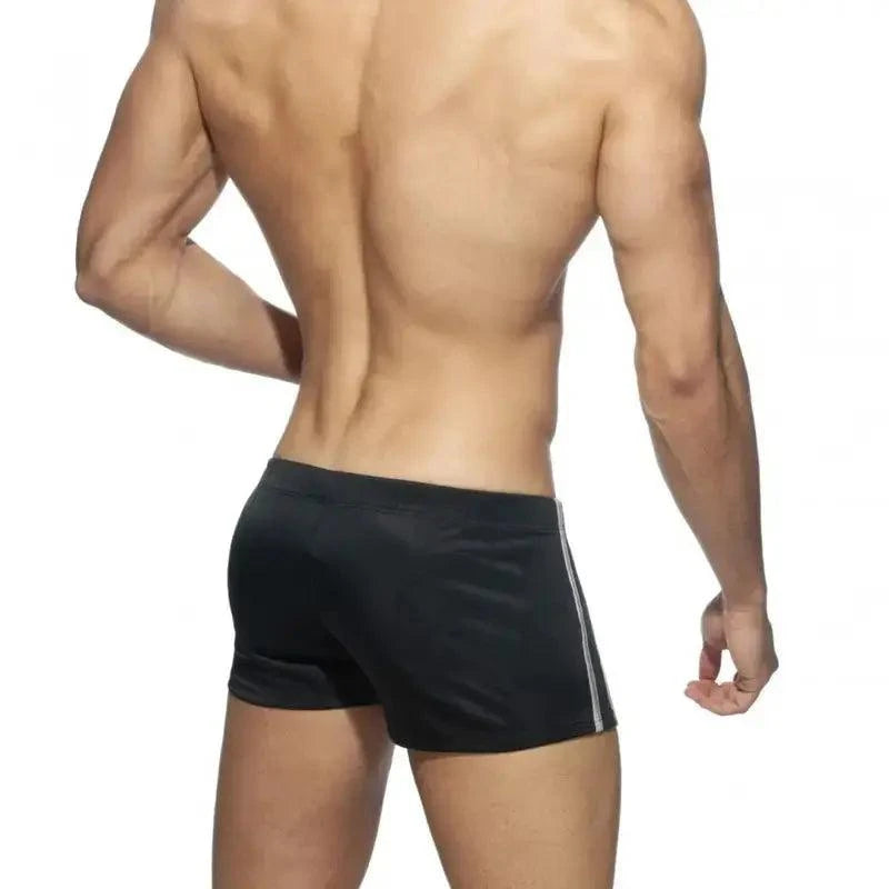 DomiGe faux leather swim boxers in black — model rear view	