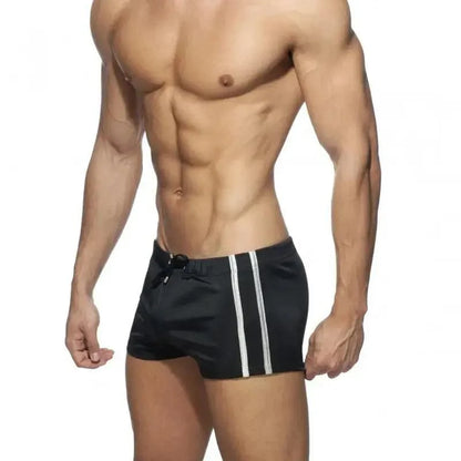 DomiGe faux leather swim boxers in black — model side view	