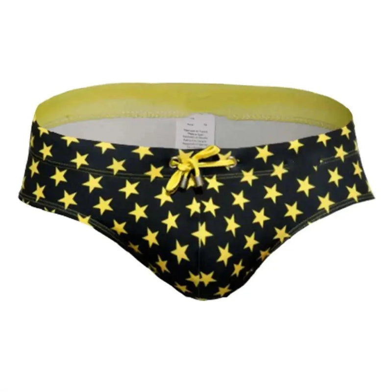 DomiGe flag print swim briefs in yellow — product detail showing fabric and flag print	