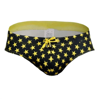 DomiGe flag print swim briefs in yellow — product detail showing fabric and flag print	