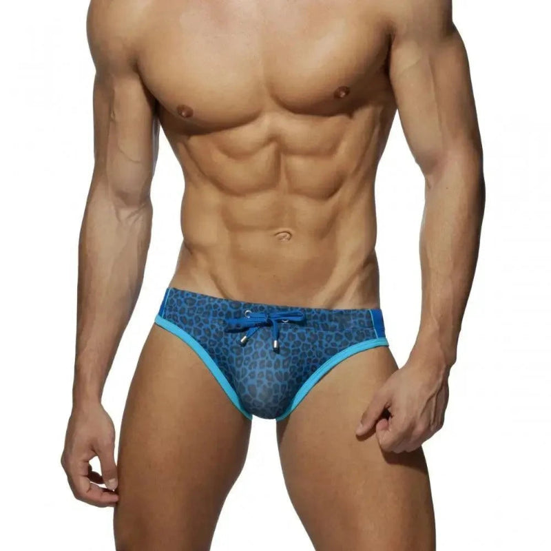 DomiGe leopard print swim briefs in blue — model front view	