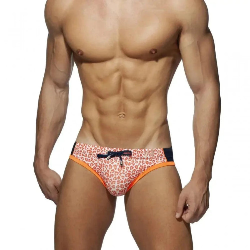 DomiGe leopard print swim briefs in orange — model front view	