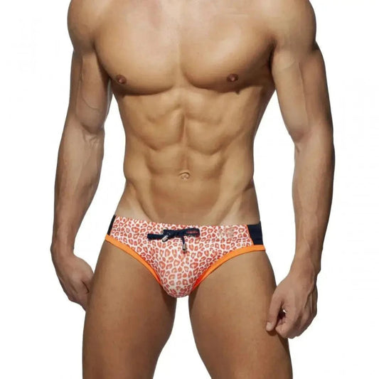 DomiGe leopard print swim briefs in orange — model front view	