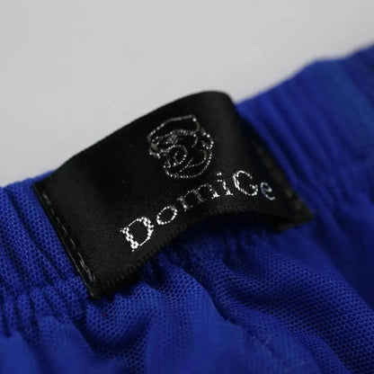 Close-up of DomiGe logo on Comfort Flex Waistband — blue modal mesh boxer briefs with adaptive fit	
