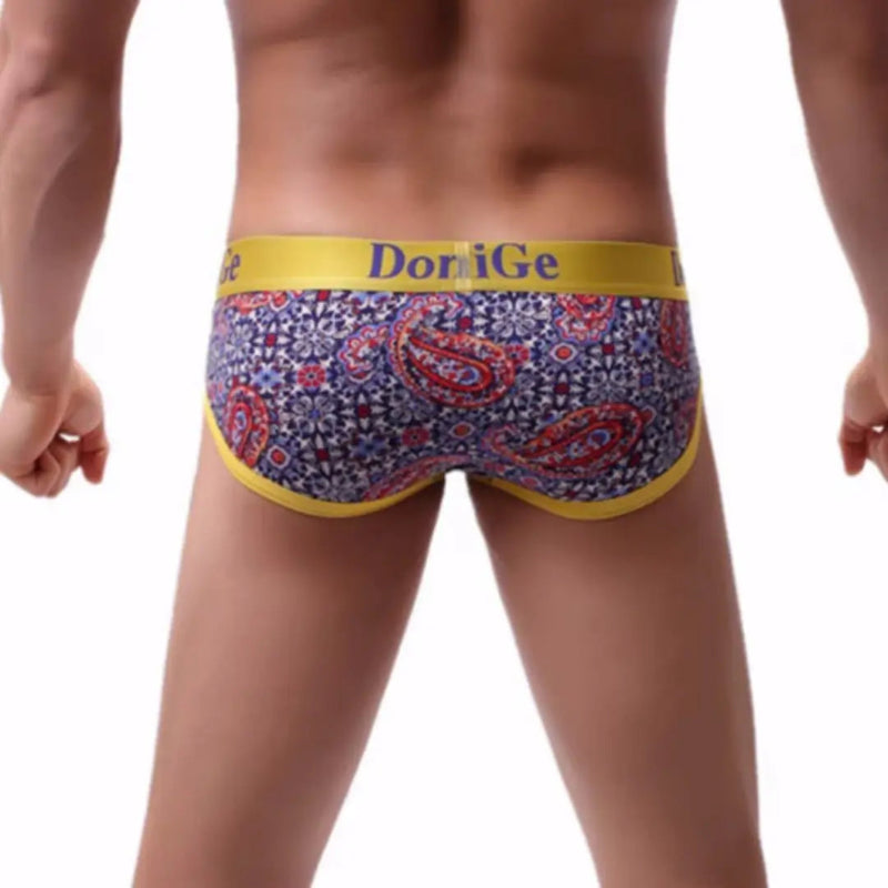 Rear view of DomiGe red paisley print briefs — seamless one-piece back with no center seam	