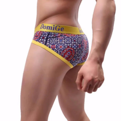 Side view of DomiGe red paisley print briefs — seamless rear design with rolled hem leg openings	
