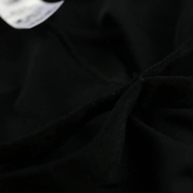 DomiGe X-Design jockstrap in black — flat lay side view showing waistband and strap construction	