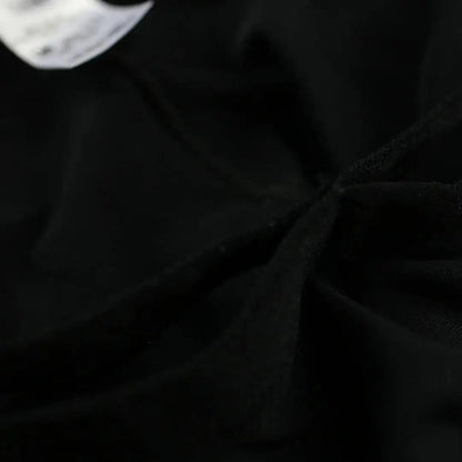 DomiGe X-Design jockstrap in black — flat lay side view showing waistband and strap construction	